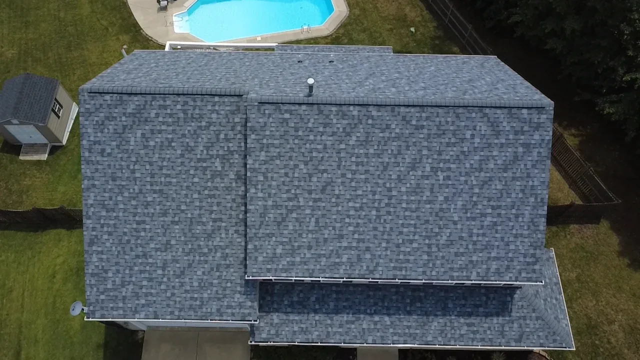 Aerial view of slate gray architectural shingle roof installation on residential home