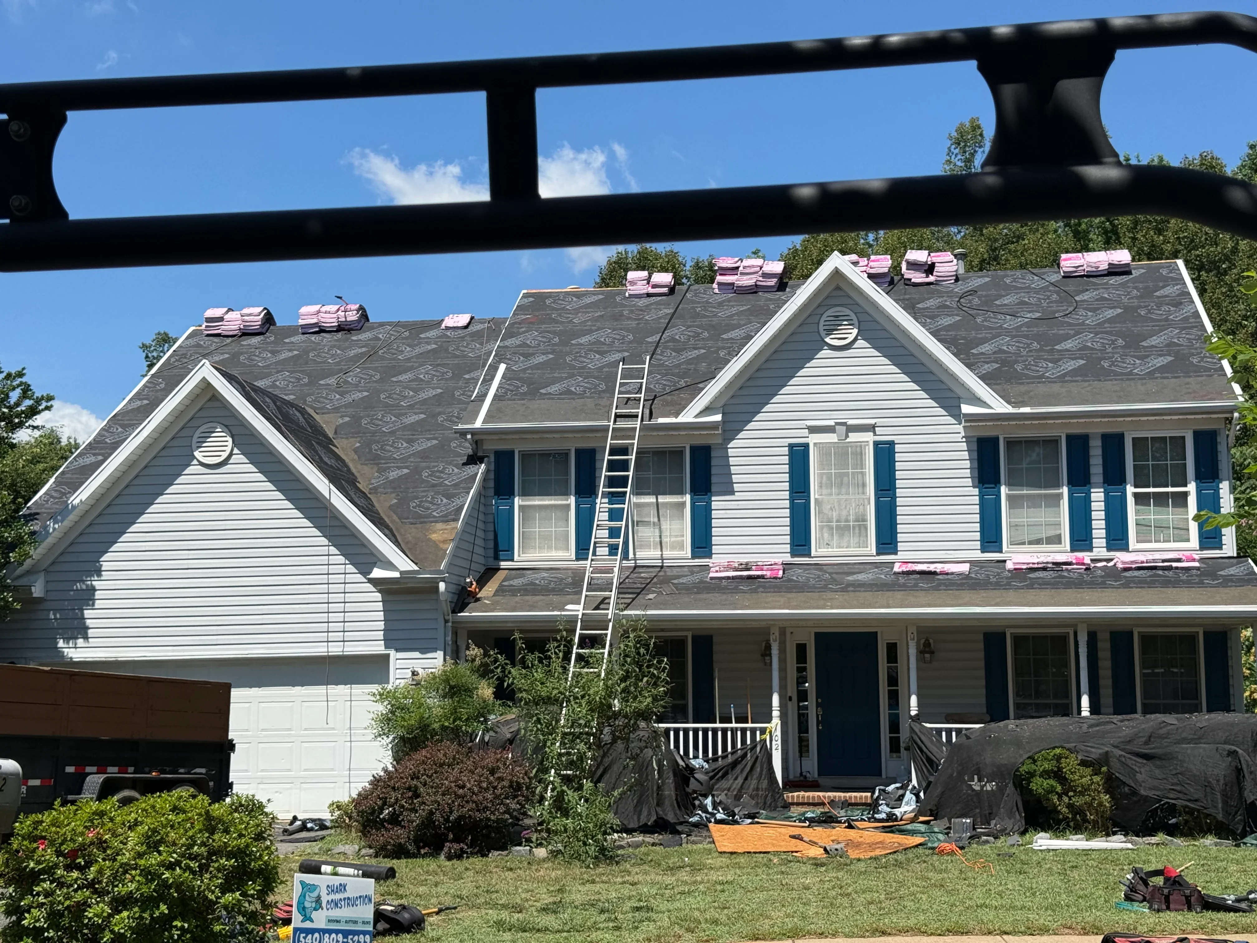 Two-story home with new charcoal gray architectural shingles installed on multiple roof planes