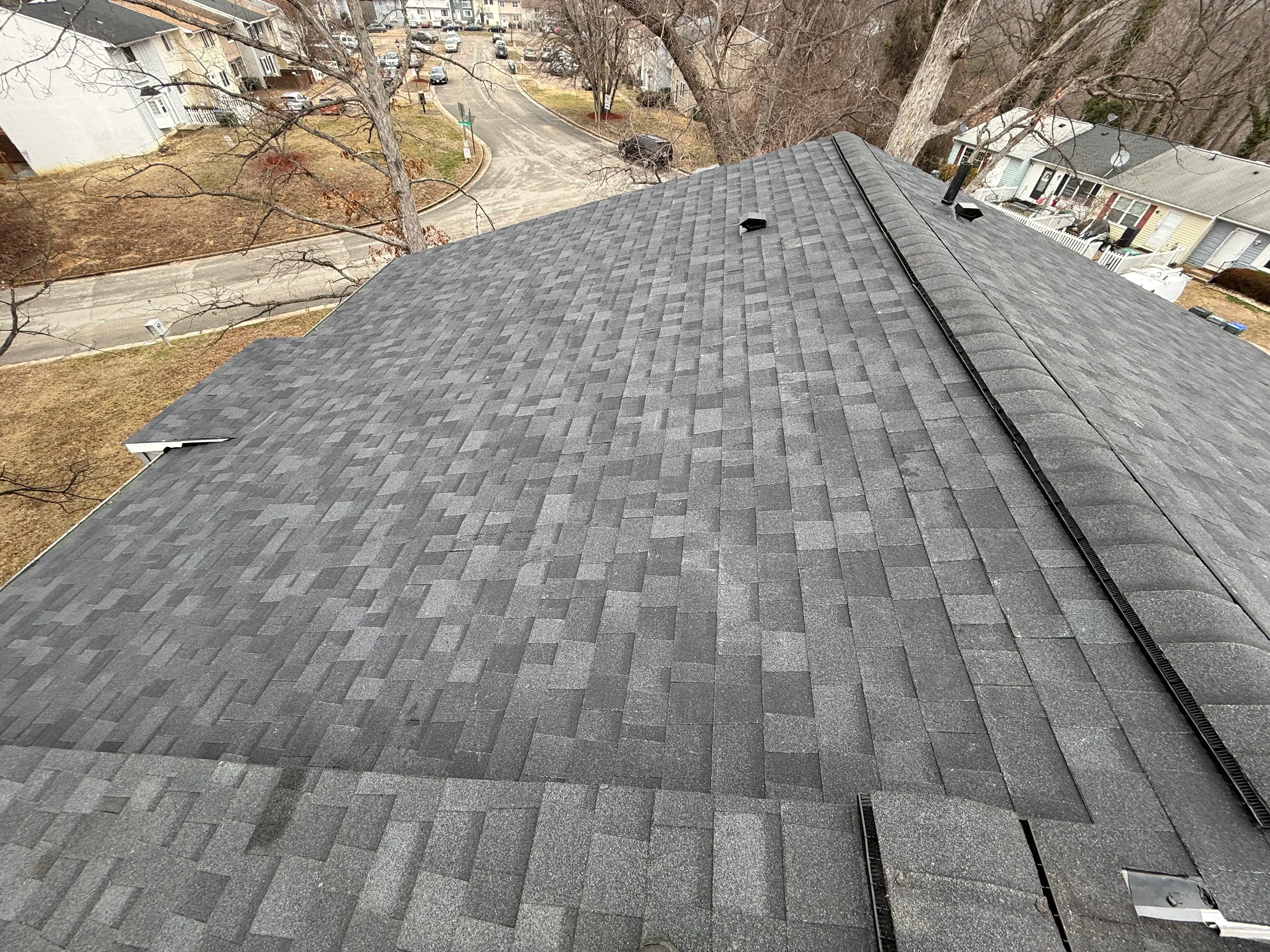 Charcoal gray architectural shingles installed in staggered pattern on residential roof