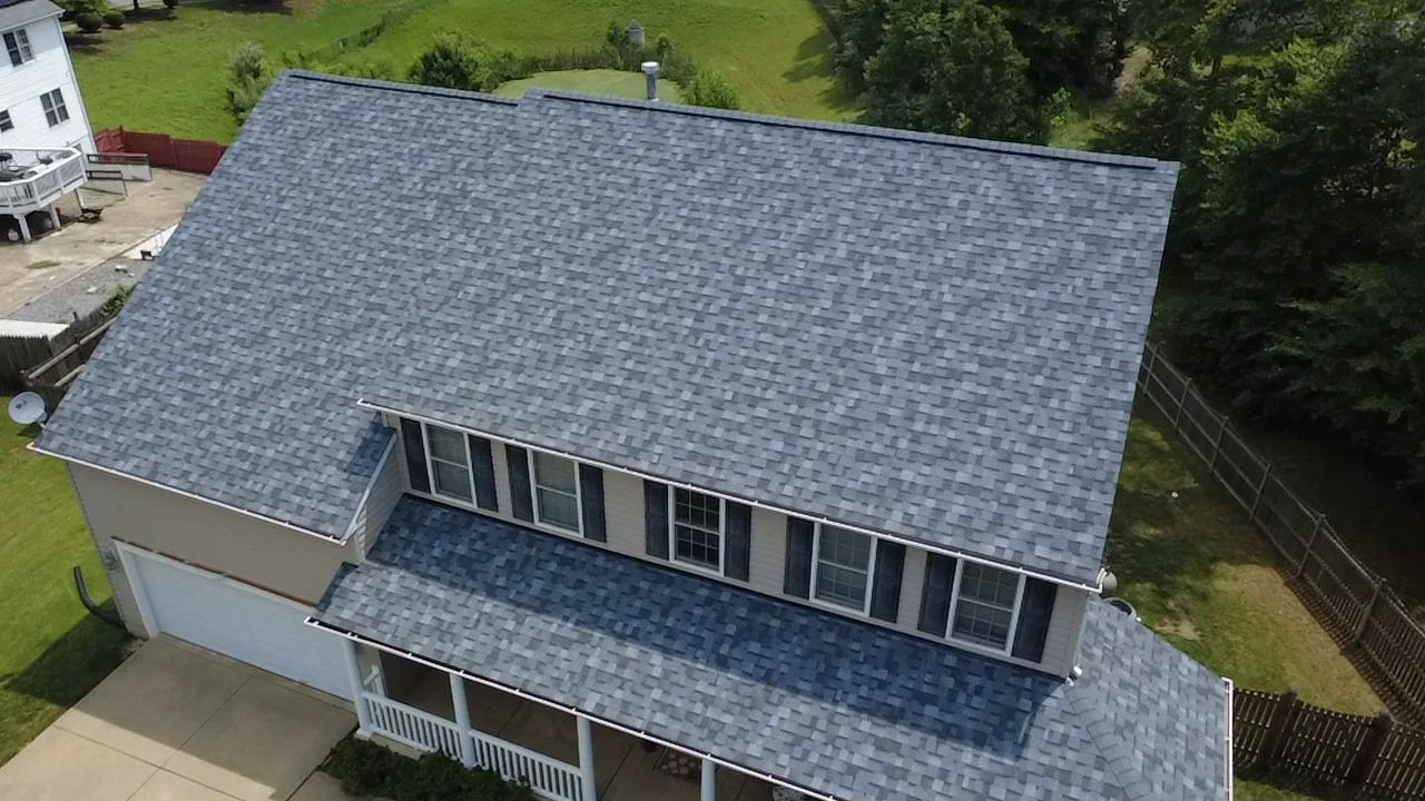 Slate blue architectural shingle roof on two-story home with multiple planes and window flashing